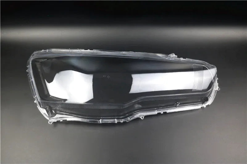 Transparent plastic vehicle headlight housing cover showing dimensions.