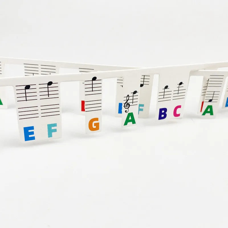 White cardboard piano keyboard stickers for 88 keys with colour note bars and black note labels