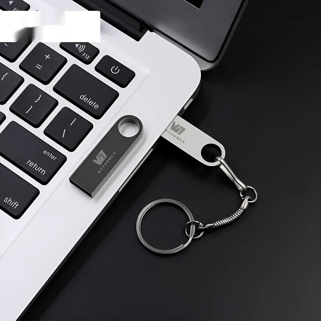 Silver metal car-shaped USB flash drive showing USB connector and compact size.
