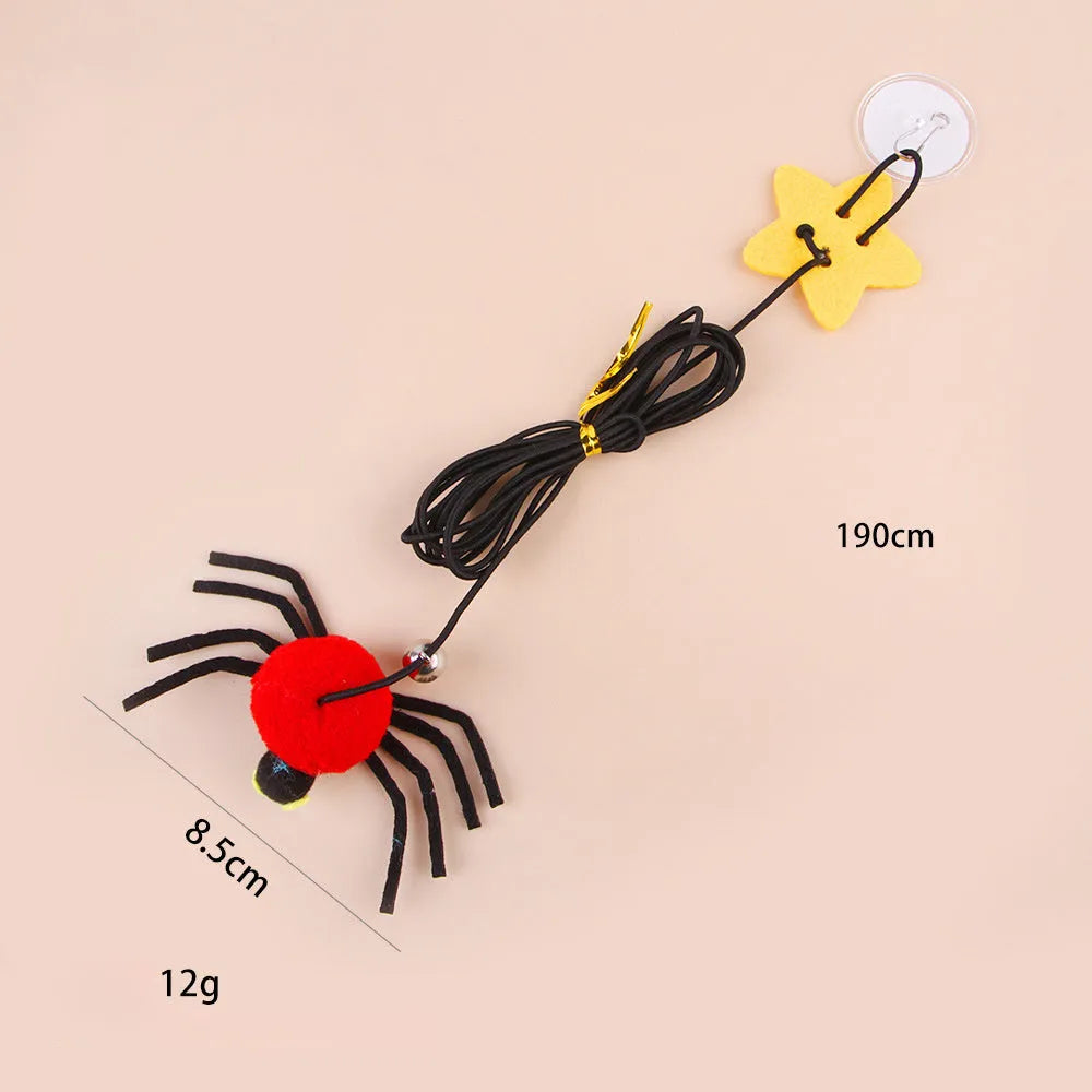 Hanging elastic rope cat toy with feather, bell and spider elements on playing stick in red colour