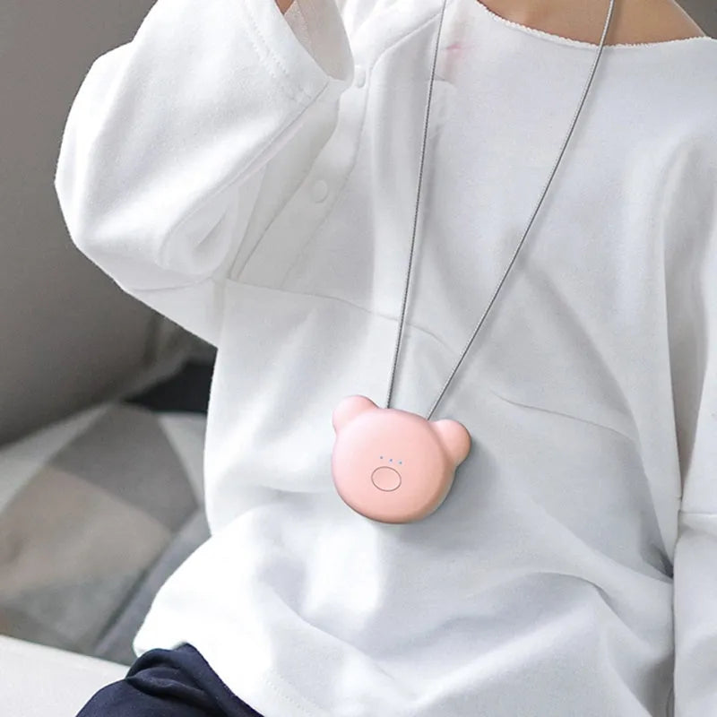 Mini USB portable air purifier necklace in pink, showing compact design with a wearable collar.