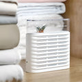 White reusable electric dehumidifier box with transparent top showing orange silica gel beads.
