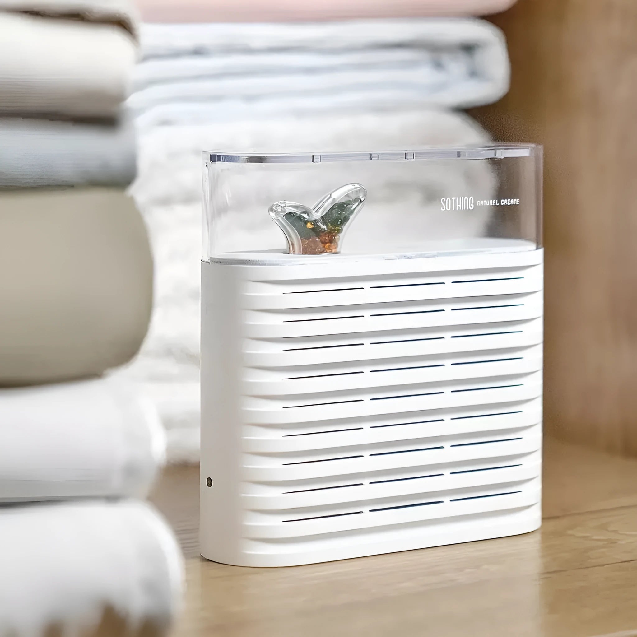 White reusable electric dehumidifier box with transparent top showing orange silica gel beads.