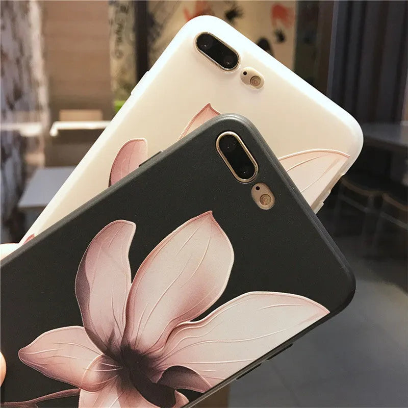Black embossed iPhone case with a single white floral design on the back.