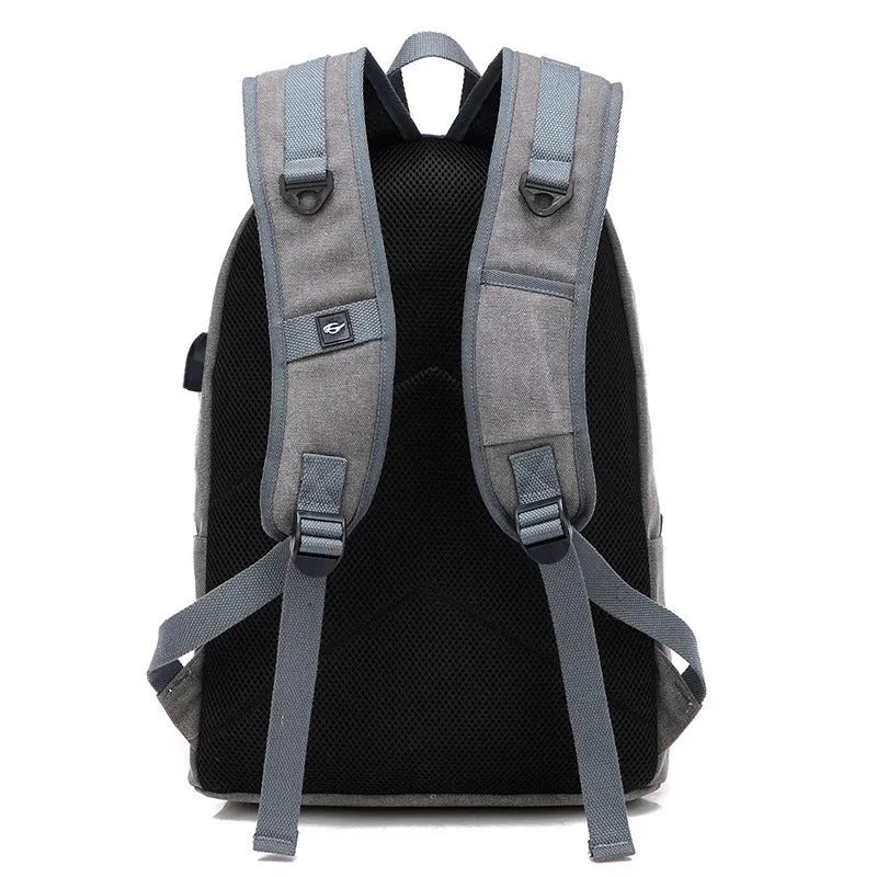 Canvas USB rechargeable backpack with laptop compartment showing multiple storage pockets