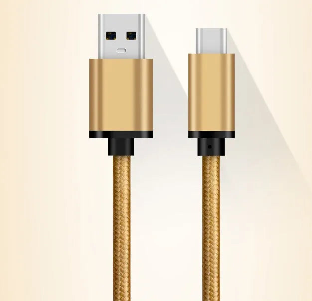 Gold USB Type-C to USB 3.0 braided charging cable with metal plugs on a white background.