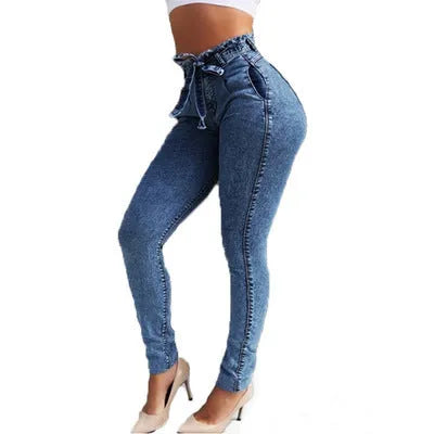 Women's fringed jeans in dark blue denim with frayed hem detailing, size chart displayed