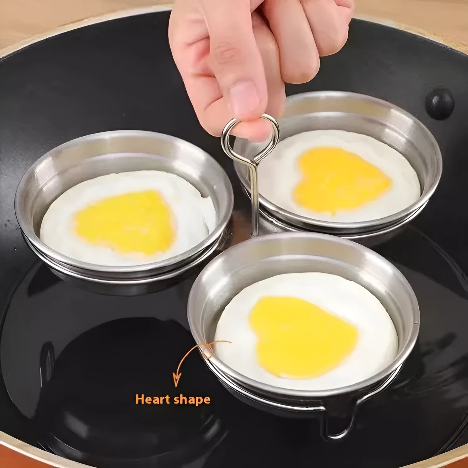 Mini stainless steel egg steamer in heart-shaped design with compact kitchen appliance dimensions