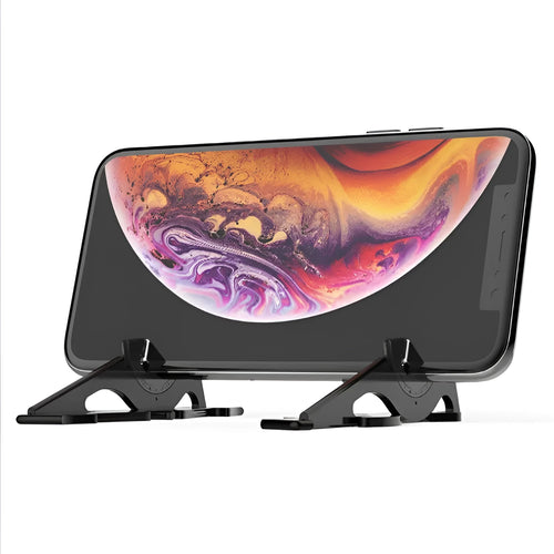 Black plastic card-type mobile phone holder on a wooden desk