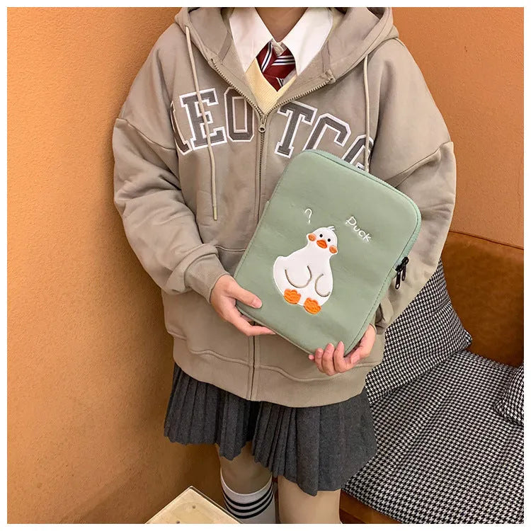 Blue cotton tablet case with embroidered cartoon duck design and a zipper.