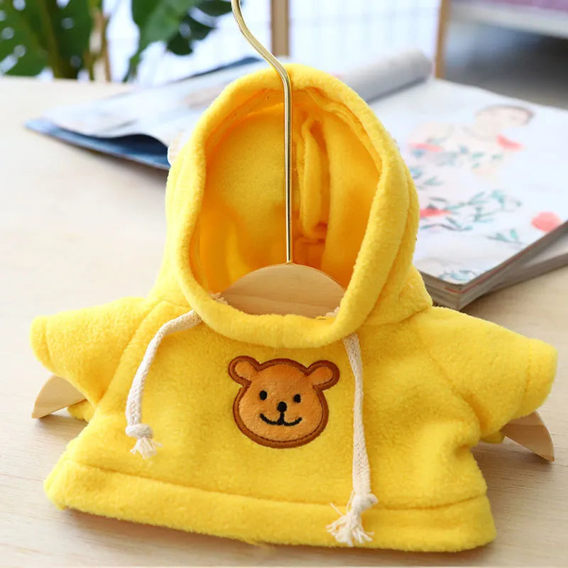 A small dog wearing a blue cloth hoodie sweater from the range of six available colours.