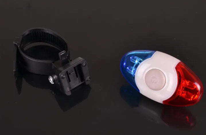 Red and blue LED bicycle tail light with adjustable mounting base shown in horizontal position.