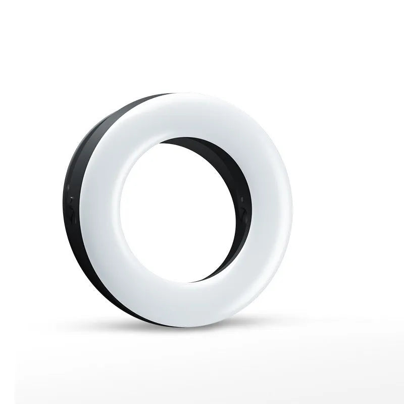 Compact black LED selfie ring light for mobile phone with USB cable for recharging.