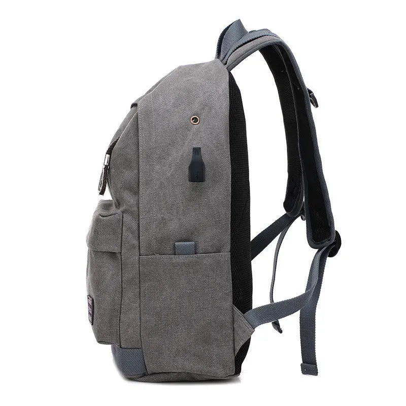 Canvas USB rechargeable backpack with laptop compartment showing multiple storage pockets