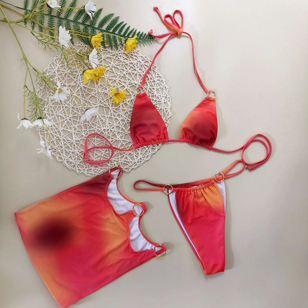 Tie-dye gradient three-piece halter bikini swimsuit set with skirt on a mannequin.