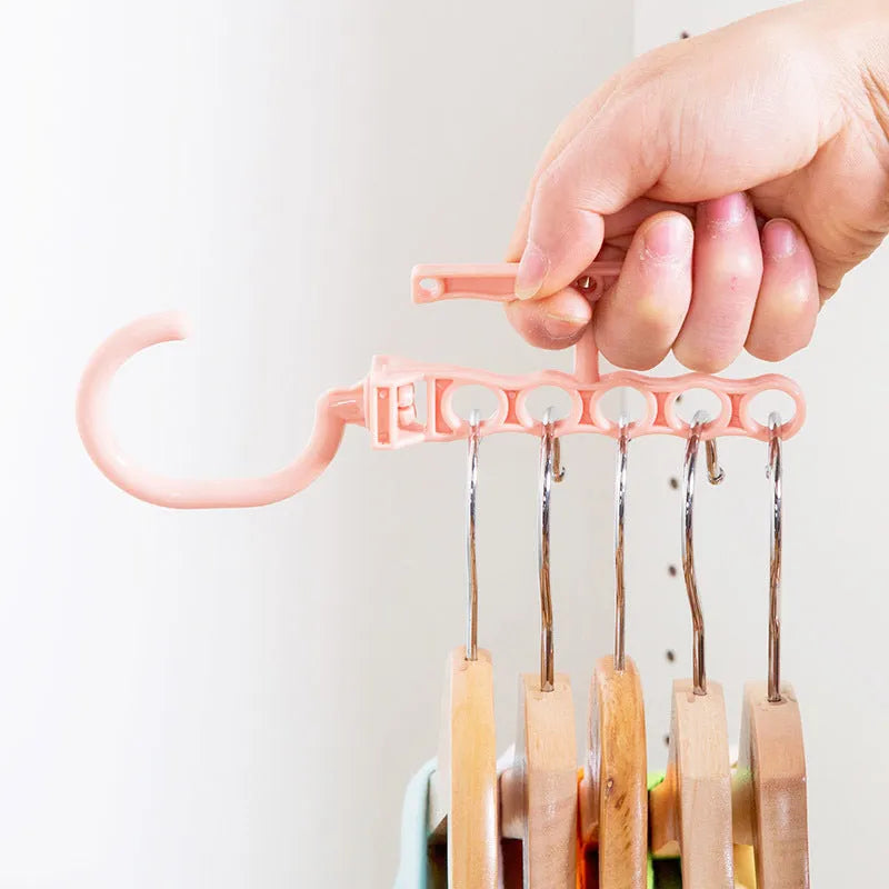 Blue revolving wardrobe hanger with five branches and handle for clothes organisation