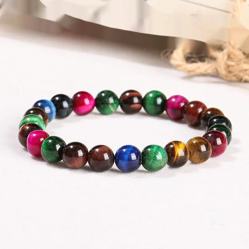 A colourful natural Tiger Eye beaded bracelet showing round beads on a string.