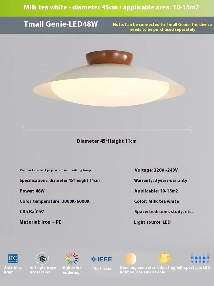 Modern cream-style flying saucer shaped ceiling lamp in a bedroom setting.