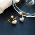 Women's heart-shaped pearl stud earrings with alloy inlaid gems and an electroplated finish.