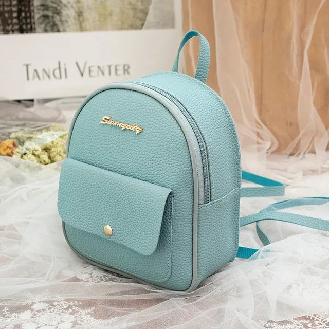 Women's black PU backpack purse with letter design and shoulder strap showing compact 18.5cm length