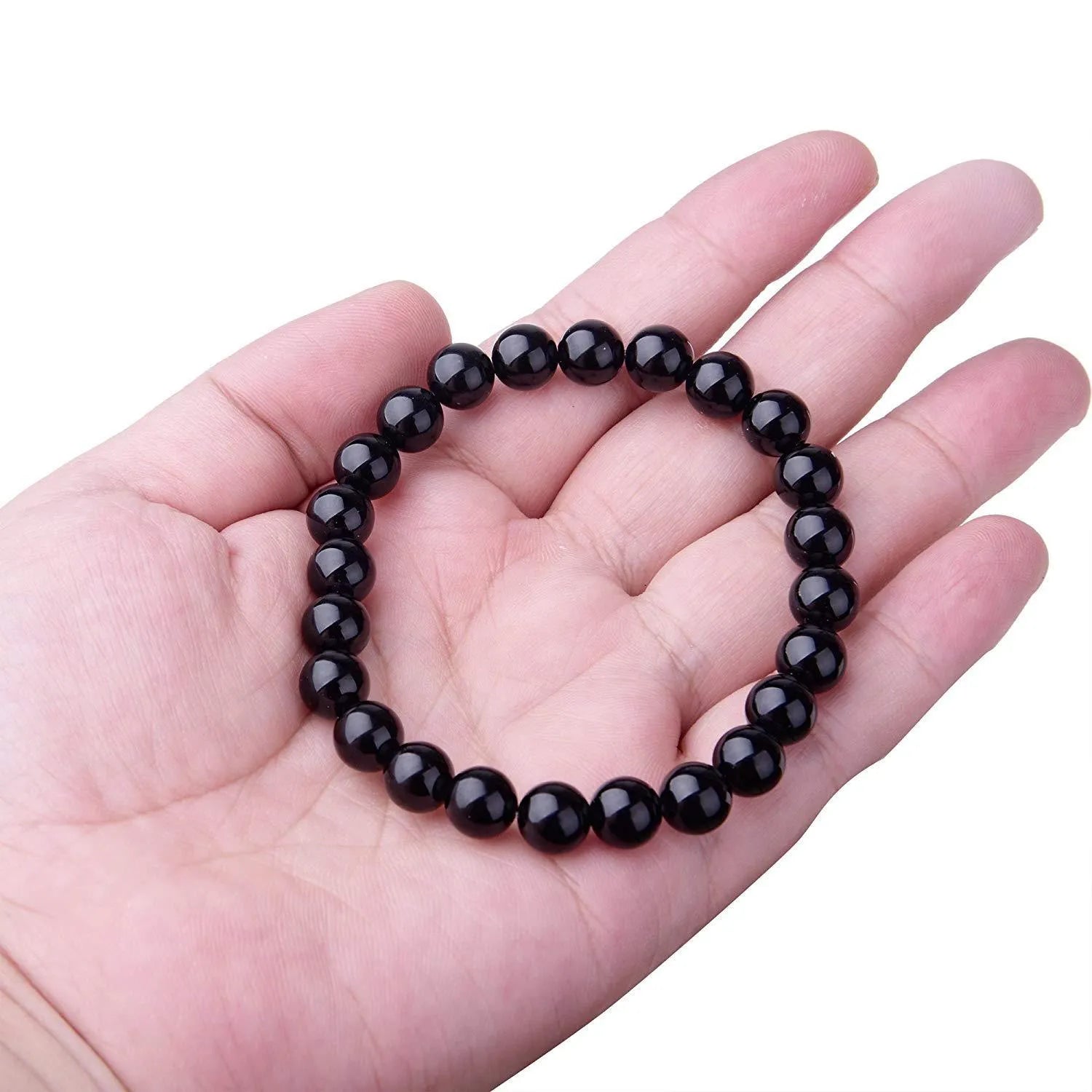 Geometric black agate bead bracelet on elastic cord, showing 8mm bead size.