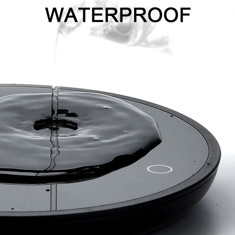 Black coffee mug warmer on desk showing 12cm diameter and low/high temperature switch