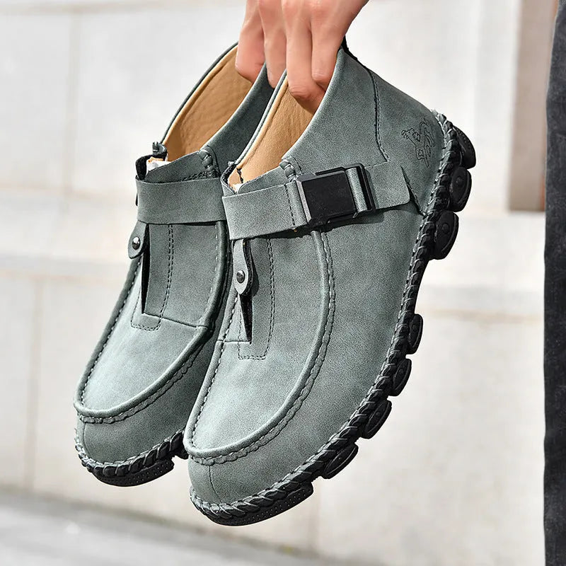 Men's black casual slip on loafers with visible stitching and a flat sole.