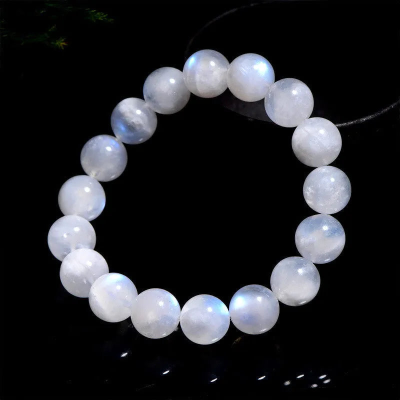 Natural blue moonlight round moonstone bead bracelet on wrist showing polished surface