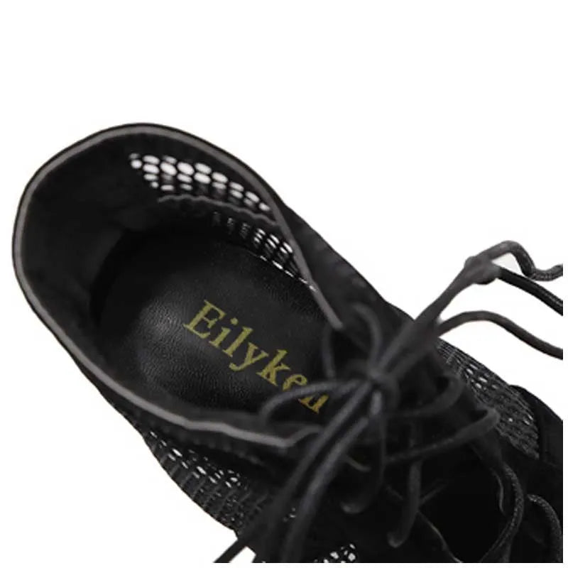 Black suede women's lace-up high heel shoes with a high stiletto heel on a plain background