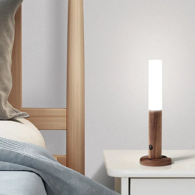 Smart sensor LED desk lamp with solid wood base and clear acrylic shade on a wooden table.