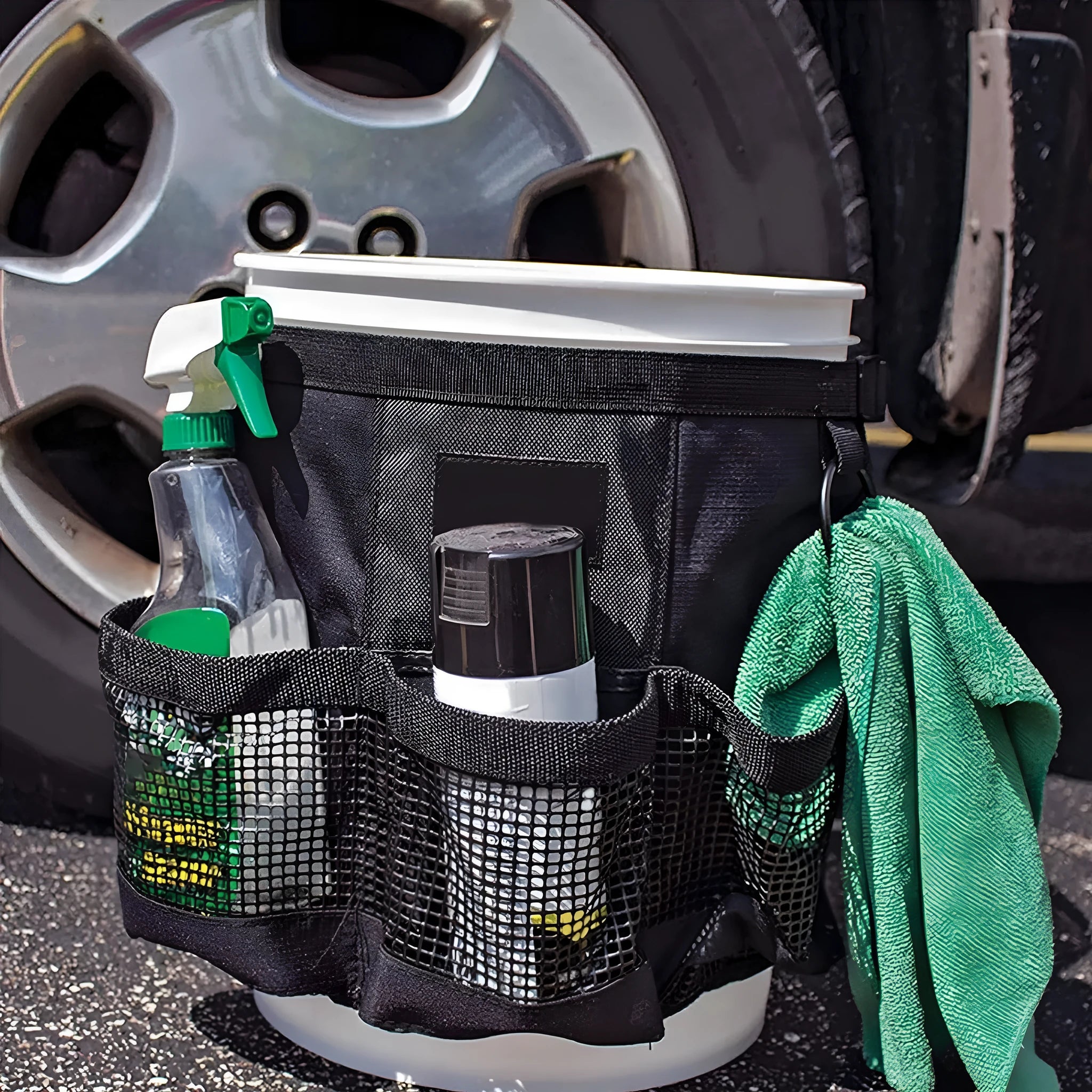 Black cylindrical polyester hanging storage bag shown fitted on a 5 gallon barrel.