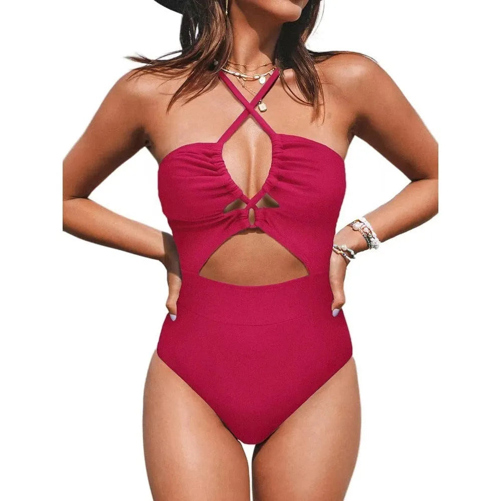 Women's black cross-back one-piece swimsuit with backless design and solid colour pattern