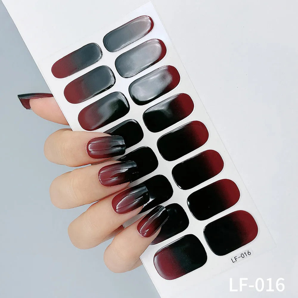 Set of 16 solid colour nail art stickers showing floral, geometric, and pattern designs for manicure application