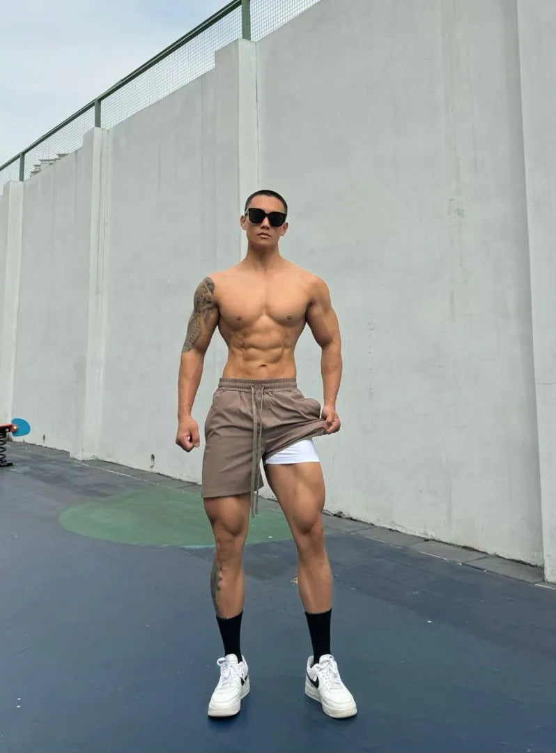 Man wearing grey ice silk quick-drying double-layer quarter shorts on a casual day out.