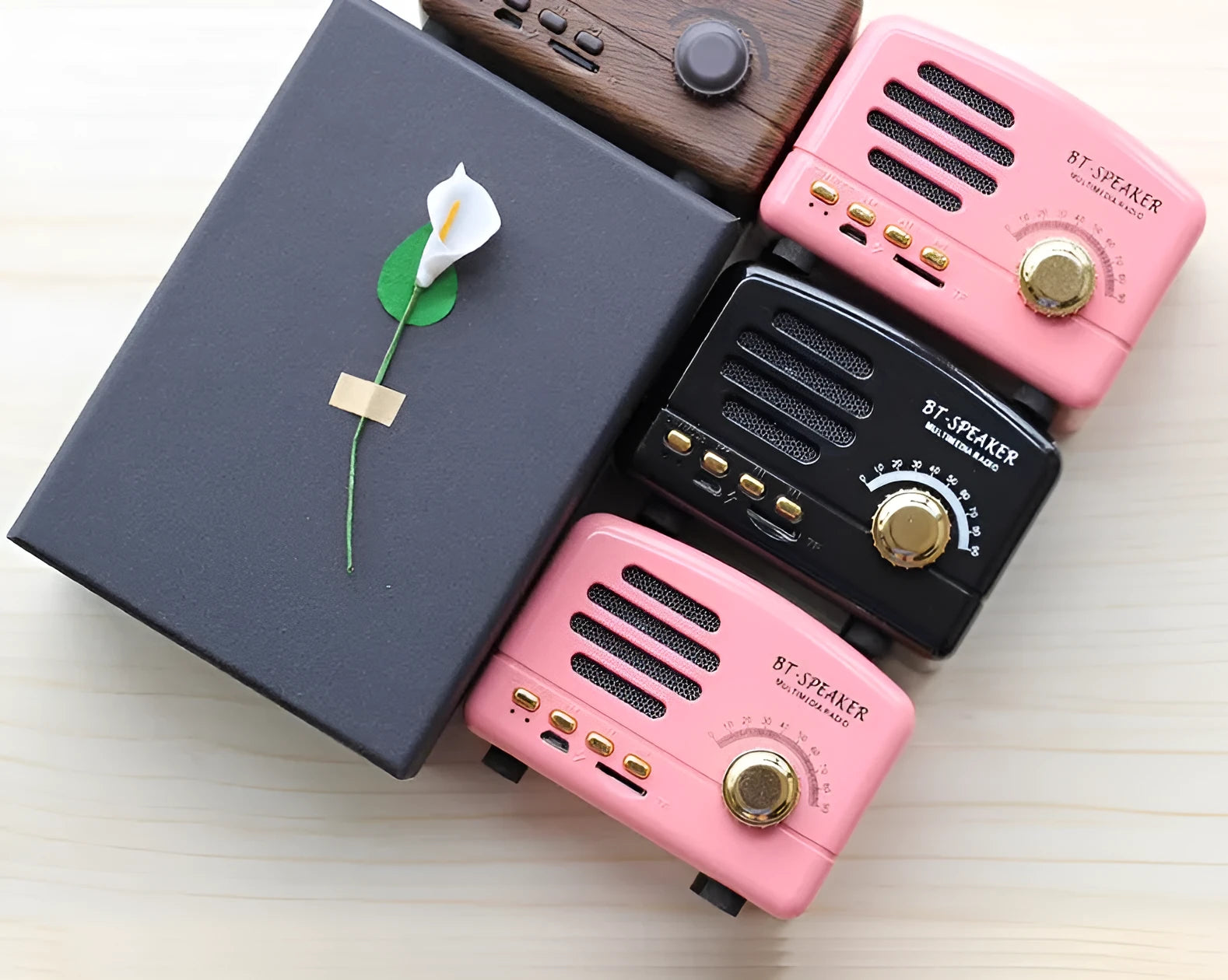 Wood grain finish bluetooth speaker showing compact design with USB charging port
