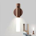 Smart sensor LED desk lamp with solid wood base and clear acrylic shade on a wooden table.