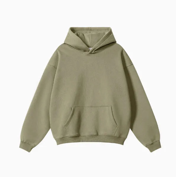 Man wearing a loose-fit grey cotton hooded sweater with drop-shoulder sleeves.
