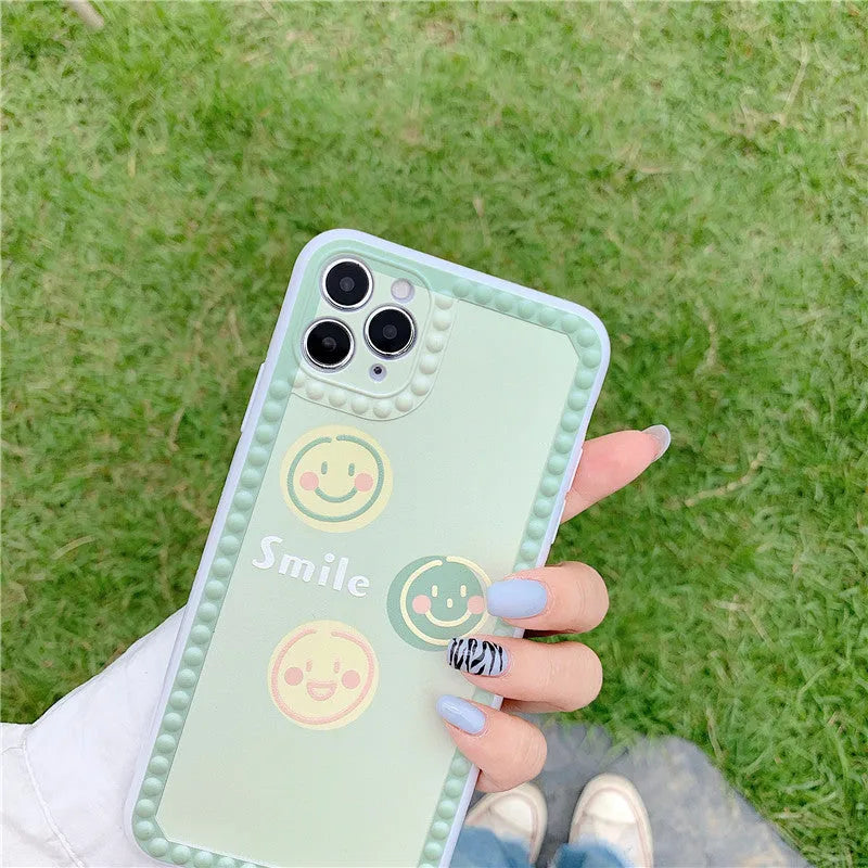 Green TPU iPhone case featuring a geometric smiley face and polka dot frame design.