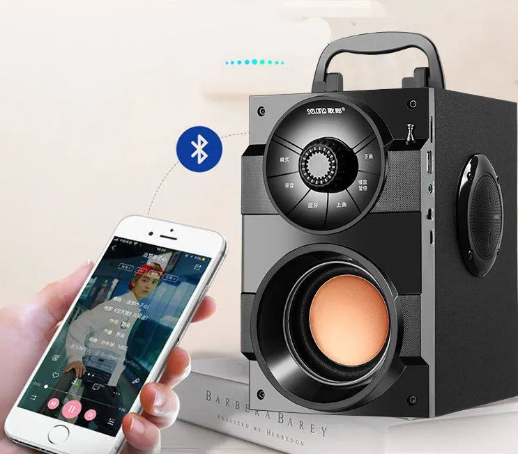 Black portable mini home audio system with subwoofer, satellite speakers, and a connected USB charging cable.