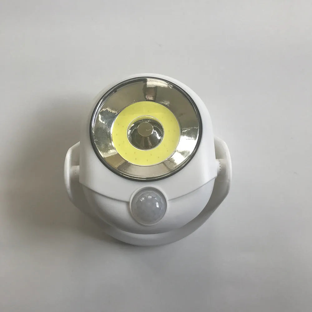 White Atomic Angel induction lamp made of ABS plastic on a plain background