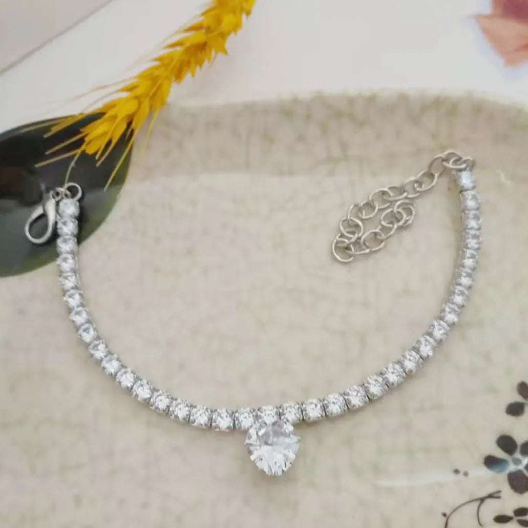 Gold rhinestone heart design pet collar for cats and dogs on a white background.