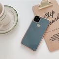 TPU iPhone case with solid colour and a raised metallic love heart design on the back.