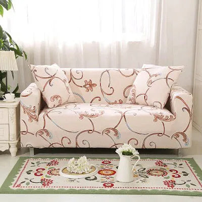 Geometric abstract printed stretch sofa slipcover covering a three-seater sofa with matching cushion covers.