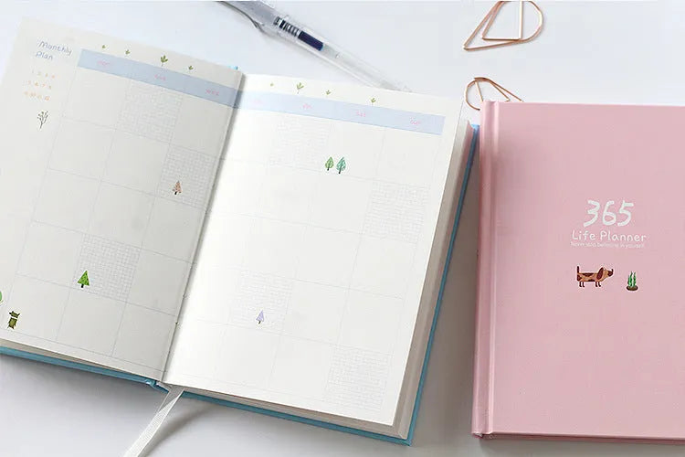 Hardback colour inside notebook planner with 228 pages, open to daily schedule, shown in Dark Green