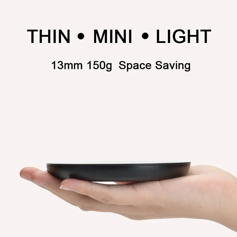 Black coffee mug warmer on desk showing 12cm diameter and low/high temperature switch