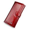 Women's red leather coin purse with a textured crocodile pattern, shown open to reveal pigskin lining.