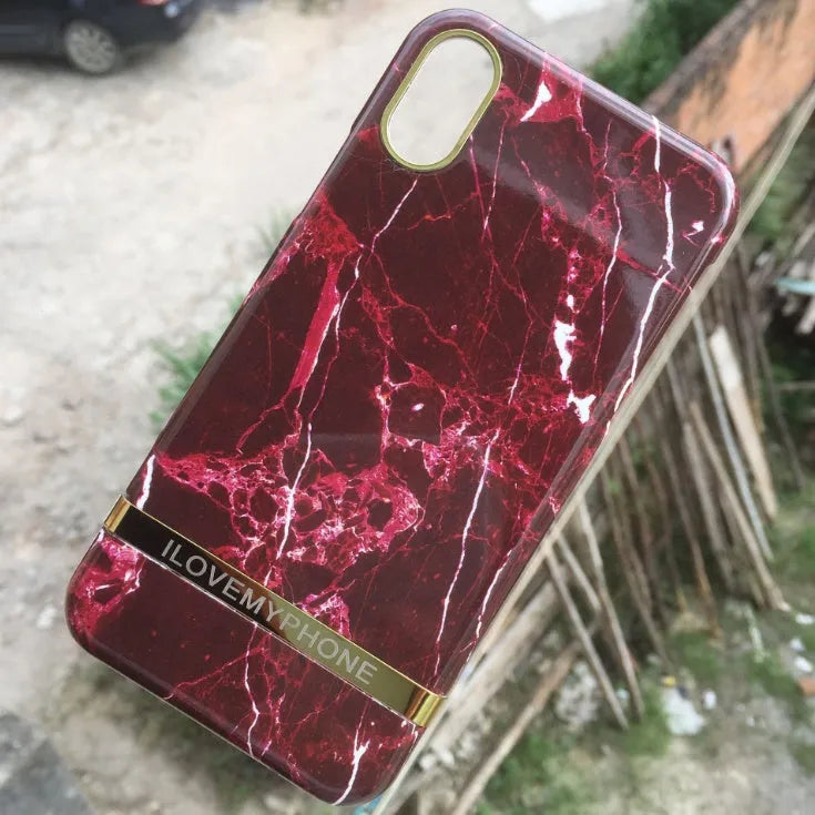 Marble pattern plastic case for iPhone on a table, shown in multiple colour options.