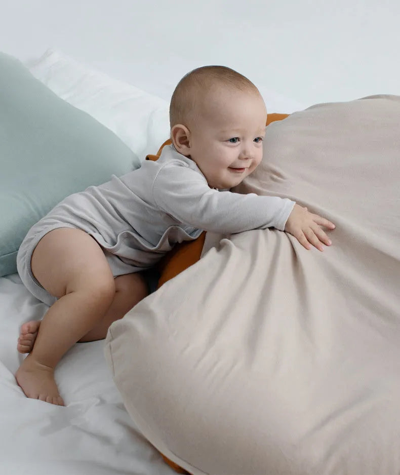 Beige portable cotton baby nest crib for newborns measuring 75cm by 45cm on a neutral background