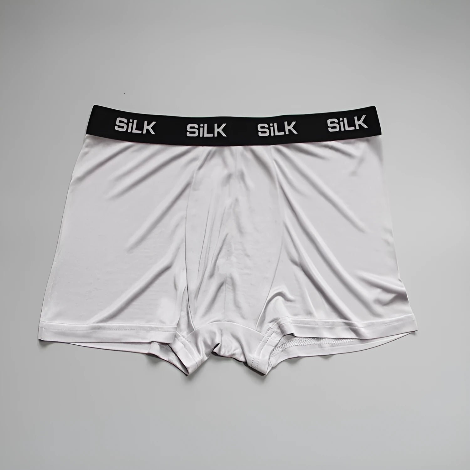 Men's loose silk shorts in navy blue, showing mid waist and relaxed fit.