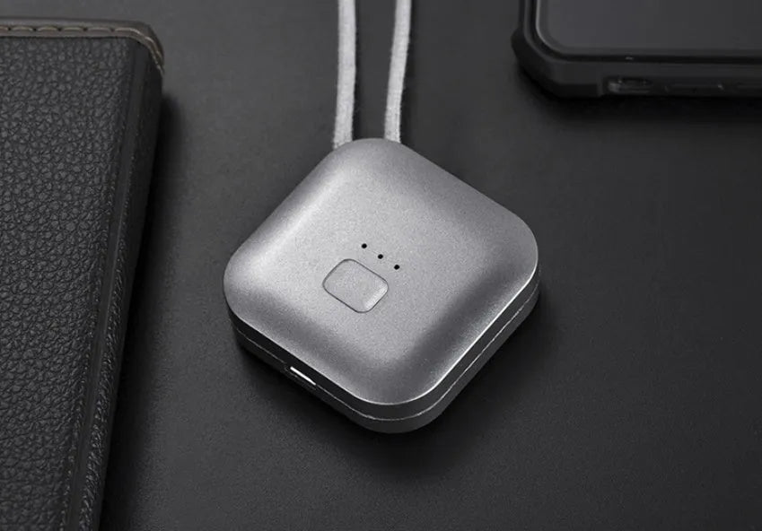 Mini USB portable air purifier necklace in pink, showing compact design with a wearable collar.